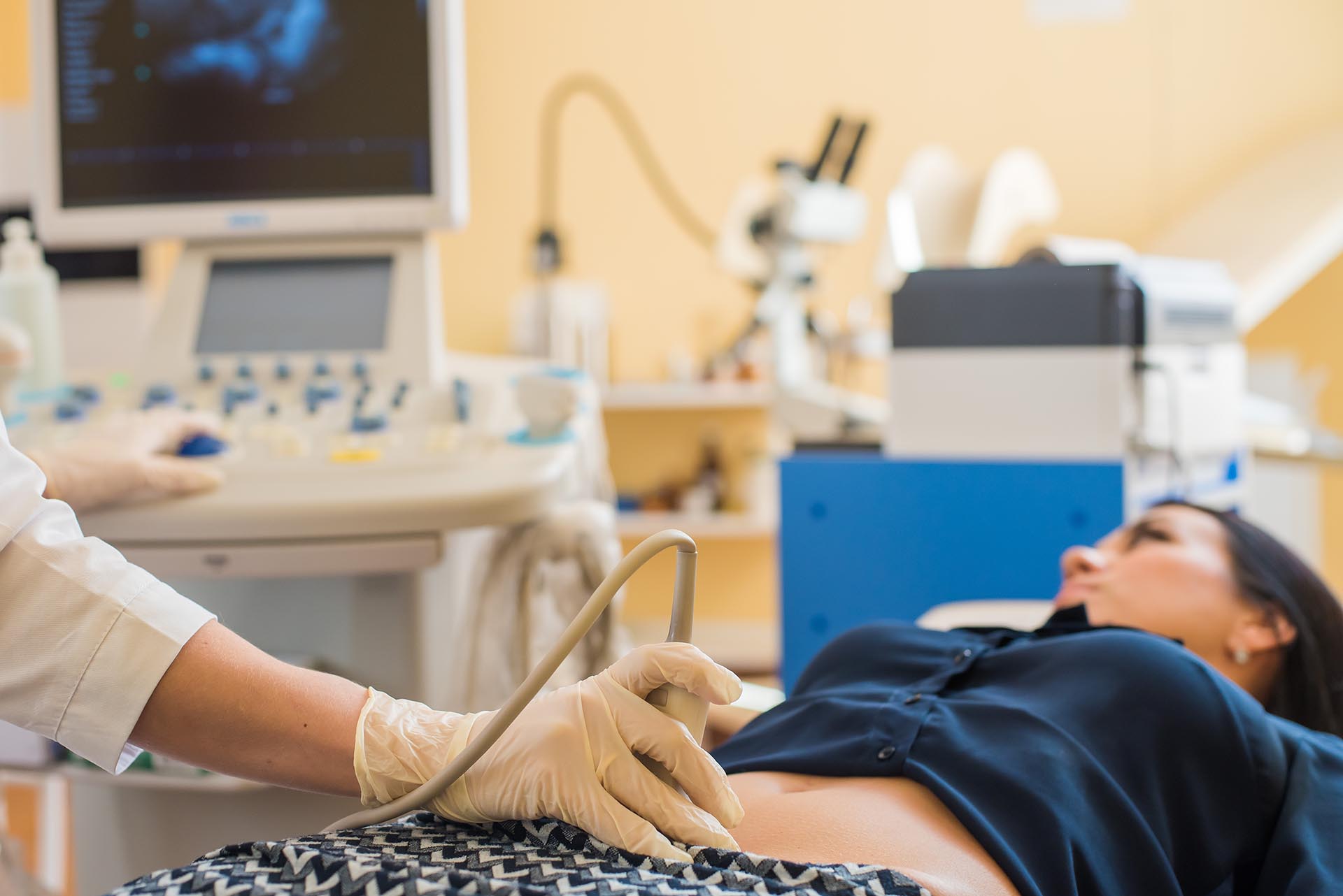 Happy pregnant female visiting women's doctor in the maternity c